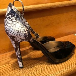 Beautiful BCBGeneration heels. Faux snake skin heel and strap. Patent open toe.